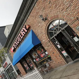 a brick building with a blue awning