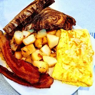 Three egg cheese omelet with hickory smoked bacon, American fries with onions and rye toast! Yummy!