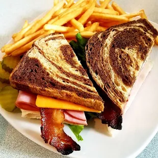 Club~Hickory smoked bacon, sliced Black Forest Ham, sliced roasted turkey, cheddar cheese, Swiss cheese, lettuce, tomato on marble rye!