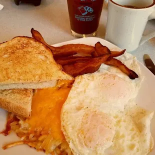 Sat. brunch ~ Perfect eggs over-easy, cheesy hash~browns, hickory smoked bacon and sour-dough toast!