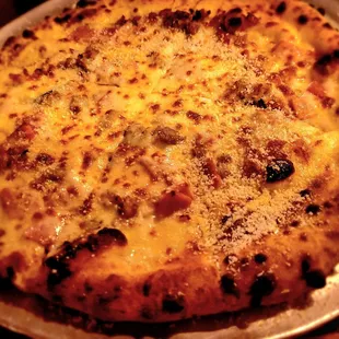Tre Porcellini Pizza - Basil leaves, rosemary ham, super bacon, spicy pork meatball, topped with smoked mozzarella.