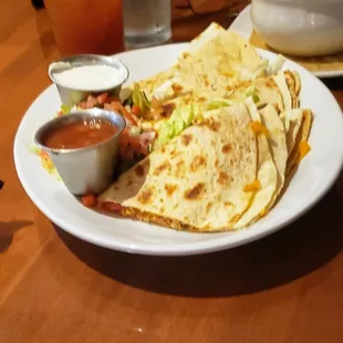 a plate of quesadillas with salsa