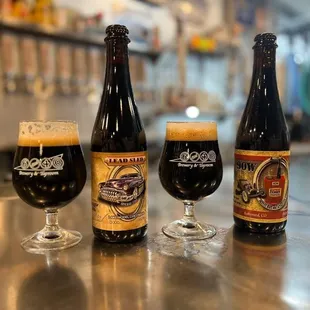 three bottles of beer on a bar