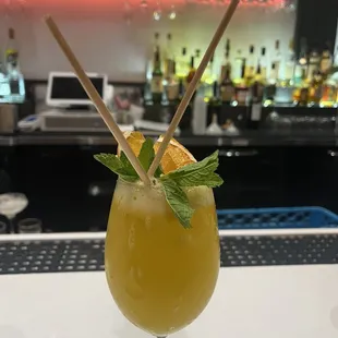 №2 BRING ON THE FRUIT pisco, midori, passion fruit, lychee, and citrus mix. shaken and garnished with orange chips, lemongrass and mint.