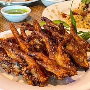 a plate of chicken wings and rice