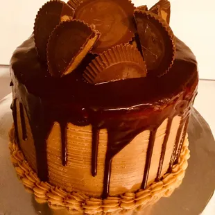 Moist chocolate cake covered with flavorful peanut butter frosting, a rich milk chocolate ganache, and topped with peanut butter cups.