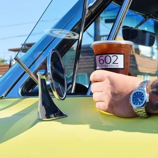 a hand holding a cup of coffee