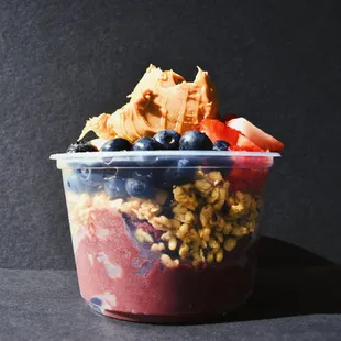 a yogurt with granola and berries