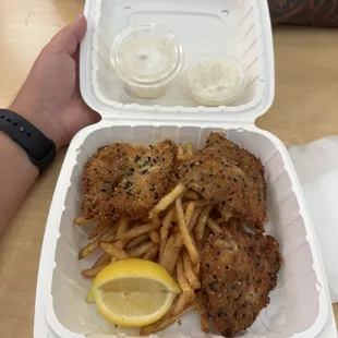 Fish and chips with tartar sauce and pineapple coleslaw