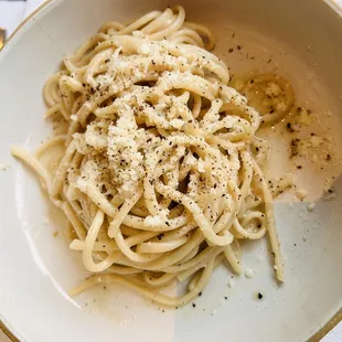 a bowl of pasta with parmesan cheese