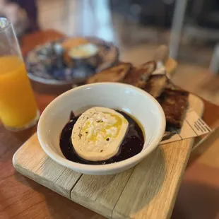 a bowl of food and a glass of orange juice