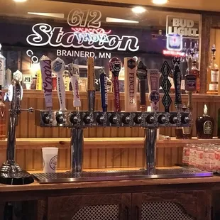 a row of beer taps on a bar