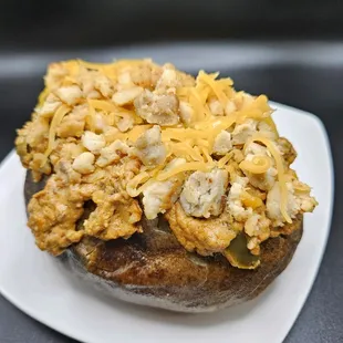 Three-C choose your tater loaded with a mildly spicy chili cheese dip, seasoned grilled chicken and shredded cheddar cheese.