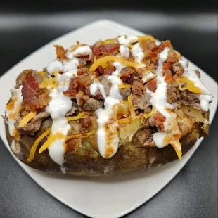 Have you tried our Steakhouse loaded with butter, A1 Steak sauce, shredded cheddar cheese, seasoned steak, bacon bits and sour cream?