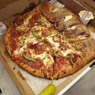 Nash style pizza- half calzone half pizza! Pepperoni green pepper pizza with sausage, bacon and onion calzone