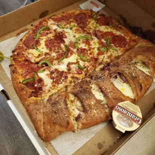 Nash style pizza- half calzone half pizza! Pepperoni green pepper pizza with sausage, bacon and onion calzone