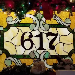 a stained glass window with christmas decorations