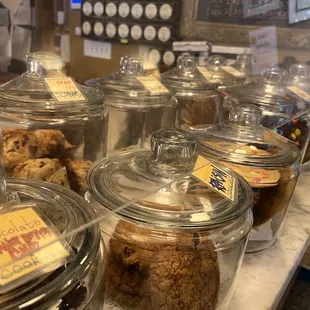 a variety of cookies in glass jars