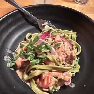 a plate of pasta with meat and vegetables