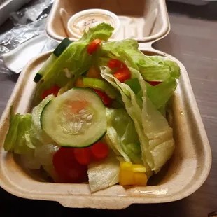 a salad in a styrofoam container