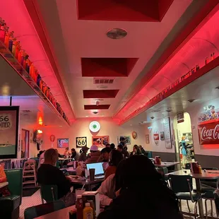 people sitting at tables in a restaurant