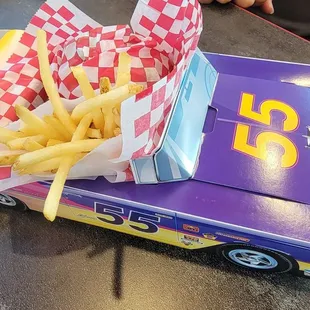 a hot dog and fries in a box