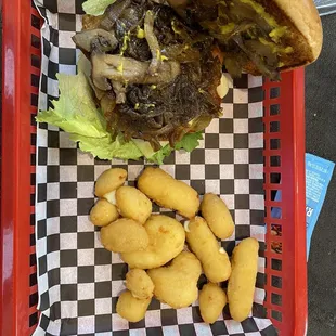 Mushroom-Swiss hamburger with all the fixings, and cheese curls. April, 2024.