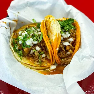 Quesatacos de Birria con Nervio: beef birria, beef tendon, onions, cilantro, cheese (90/100)