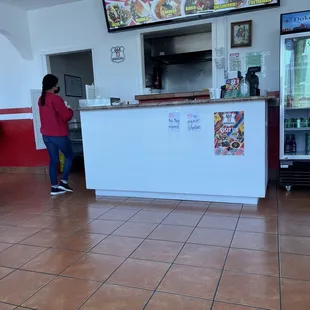 a woman standing in front of a counter