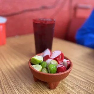 a bowl of fruit and a drink