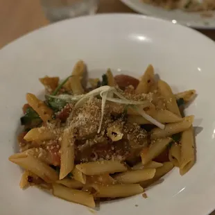 a plate of pasta with meat and vegetables