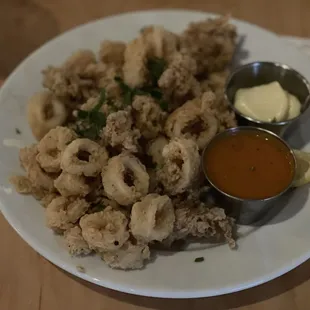 a plate of fried calamails and dipping sauce