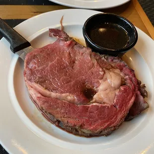 a steak on a plate with a side of mashed potatoes