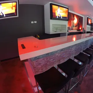 a view of a bar with tvs on the wall