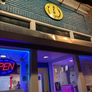 a neon sign on the outside of a restaurant