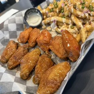 Pound of wings, half Spicy Thai and the other half is Honey BBQ. Combo comes with loaded fries and a soft drink