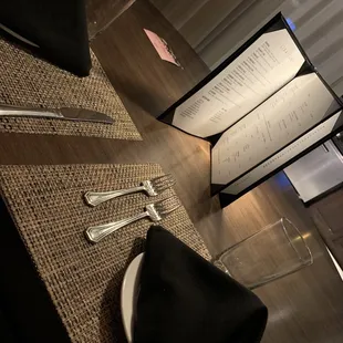 a table setting with a menu and utensils