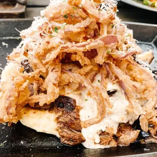 Marinated Flank Steak, covered in potato strings and this amazing horseradish sauce