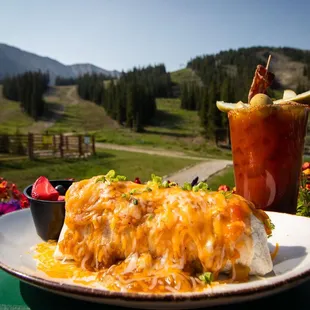 a plate of enchiladas and a drink