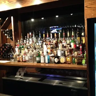 a bar with many bottles of alcohol