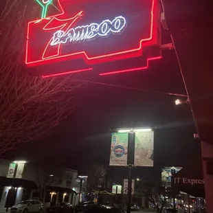 Outdoor area with wooden tables to sit, get fresh air, and enjoy the nighttime ambiance of San Jose's beautiful Japantown.