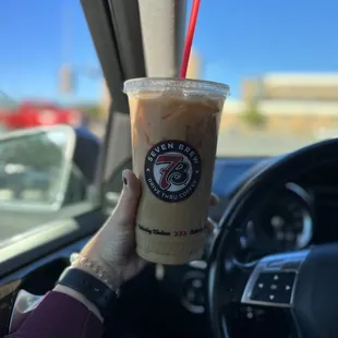 a hand holding a cup of coffee