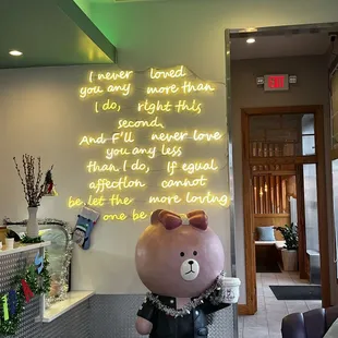 a large teddy bear statue in a lobby