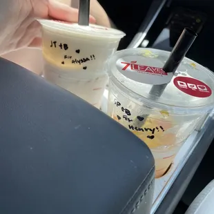 a hand holding a cup of iced coffee