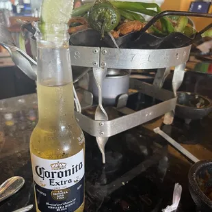 Beef, Chicken, steak fajitas over a flame served over a bucket of 6 mini Coronas $50