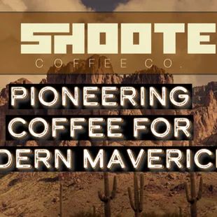 a desert scene with mountains in the background