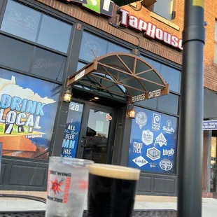 a pint of beer on a table outside