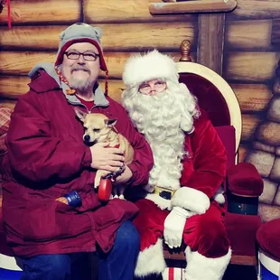 a man and a dog dressed as santa claus