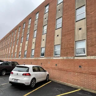 a car parked in front of a brick building