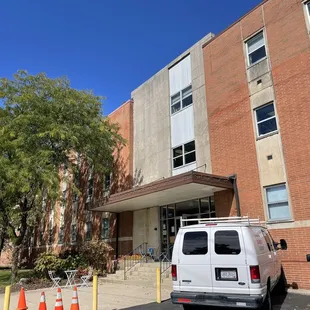 a van parked in front of a building